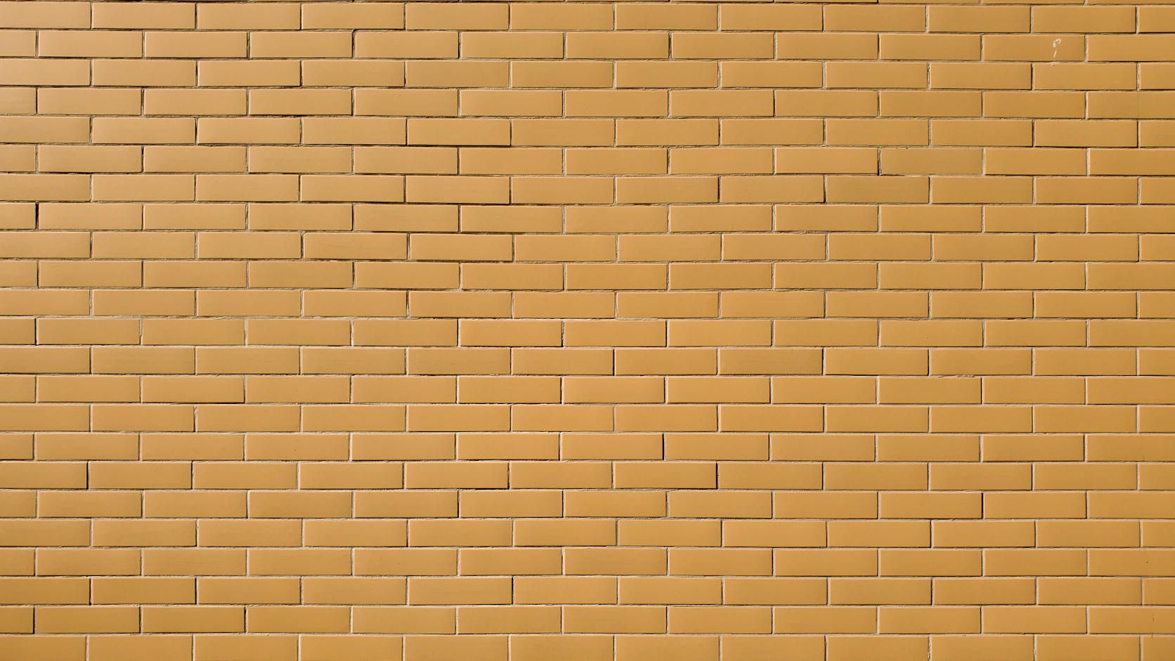 A wall of identical ochre bricks